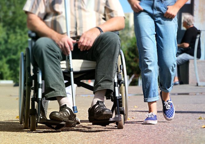 man-in-wheelchair-girl-walking-beside